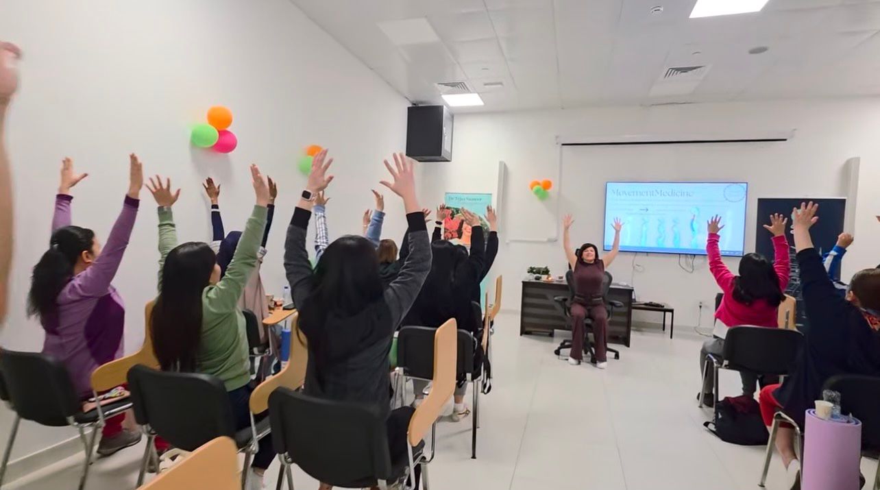 Workshop participants with hands raised